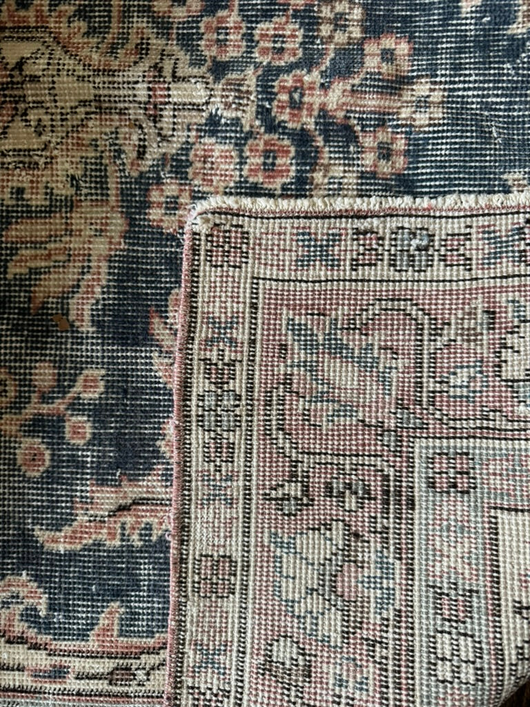 Close-up of an ornate rug with intricate patterns and colors.