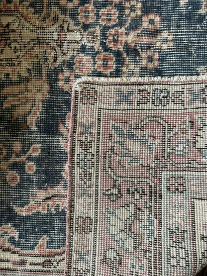 Close-up of an ornate rug with intricate patterns and colors.